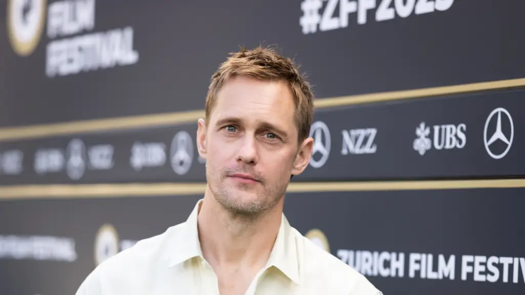 Alexander Skarsgård Turns Heads at ‘Pillion’ Premiere with Bold Fashion and Candid Insights Zurich, October 4, 2025 — Alexander Skarsgård is making waves on and off the screen as he promotes his provocative new film, Pillion. The Swedish actor stunned fans and photographers alike at the Zurich Film Festival photocall on October 1, where he appeared in a headline-grabbing, NSFW shirt adorned with risqué motifs, including dildos and other sex-related imagery. The daring fashion choice was a playful nod to the film’s bold BDSM themes and quickly became a viral moment online . Pillion, directed by Harry Lighton and distributed by A24, stars Skarsgård as Ray, a charismatic biker gang leader who enters a dominant/submissive relationship with Colin, played by Harry Melling. The film, which premiered at Cannes earlier this year, has been praised for its sharp, bike-side romance and unflinching exploration of queer intimacy and power dynamics. During the press tour, Skarsgård has been refreshingly open about the film’s explicit content and his approach to the role. He revealed that the production shot “way more graphic scenes” than what made the final cut, emphasizing that “you don’t show a close-up of a d-ck just because you can” and that the story’s emotional core was always the priority. Skarsgård also discussed his own experiences with both men and women, clarifying that while his past was “not really relevant” to the film, he appreciated the opportunity to challenge stereotypes and bring authenticity to the role . The actor’s commitment to the project extended beyond the screen, as he immersed himself in research with the Gay Bikers Motorcycle Club and spoke candidly about the realities of the BDSM community. “Leather gays are scary,” Skarsgård joked, “but I have a little bit of experience from that world and I know that’s not the truthful depiction”. With Pillion generating buzz for its fearless storytelling and Skarsgård’s magnetic performance, the film is poised to become one of the year’s most talked-about queer romances. As for Skarsgård, his willingness to embrace both the film’s themes and its promotional spectacle has only solidified his reputation as one of Hollywood’s most daring and versatile stars.