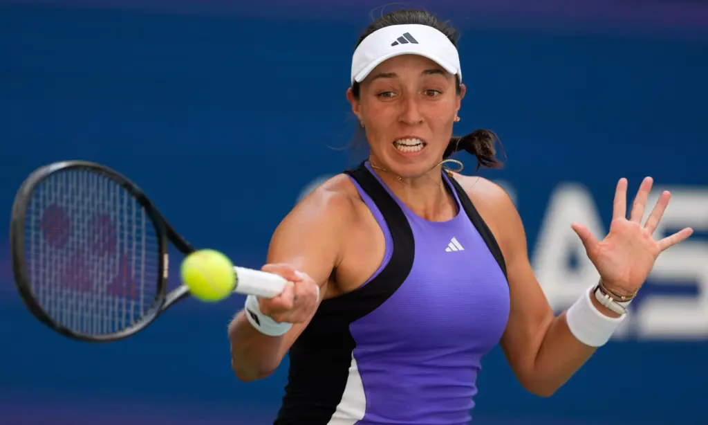 Jessica Pegula celebrates a match point on the hard courts of Beijing, her fist raised in triumph as the crowd cheers