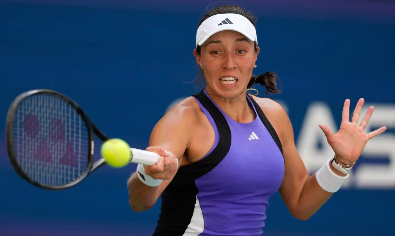 Jessica Pegula celebrates a match point on the hard courts of Beijing, her fist raised in triumph as the crowd cheers